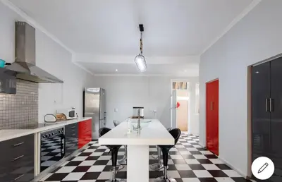 a kitchen with a black and white checkered floor at Falcon's Nest in Pretoria