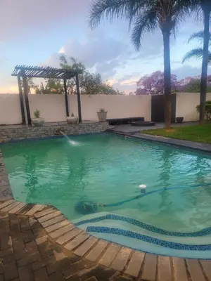 a swimming pool in the backyard of a house at Falcon's Nest in Pretoria