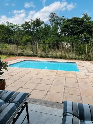 a swimming pool in a yard with a fence at Missie Villa 165 on Rooibok Euphoria Golf in Naboomspruit