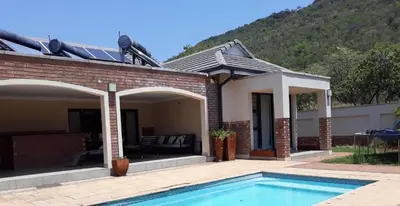 a house with a swimming pool in front of it at Missie Villa 165 on Rooibok Euphoria Golf in Naboomspruit