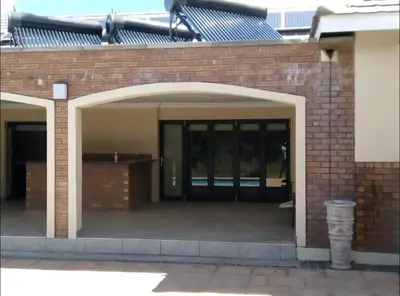 an entrance to a brick building with a glass door at Missie Villa 165 on Rooibok Euphoria Golf in Naboomspruit