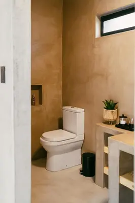 a bathroom with a white toilet in a room at Leopard's Khaya, Marloth Park in Marloth Park