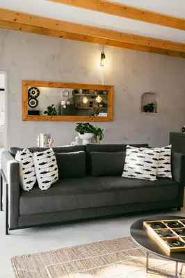 a living room with a couch and a table at Leopard's Khaya, Marloth Park in Marloth Park
