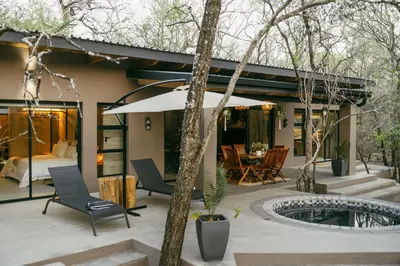 a house with a courtyard with a pool and a bedroom at Leopard's Khaya, Marloth Park in Marloth Park