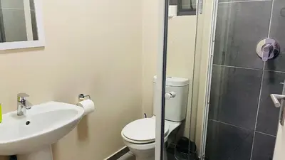 a bathroom with a toilet and a sink and a shower at Mall Of Africa Spot2 By Damo in Midrand
