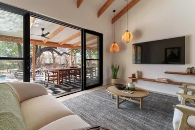 a living room with a couch and a table at Nomads Den Safari Villas - Heated Pools and Riverbed views in Hoedspruit