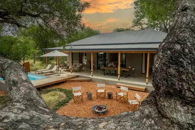 a view of a house with a tree at Nomads Den Safari Villas - Heated Pools and Riverbed views in Hoedspruit