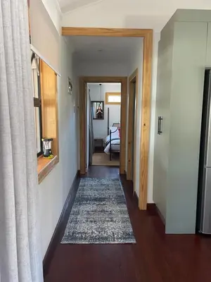 a hallway with a rug on the floor and a door at Idlewood unit 2 in Dullstroom