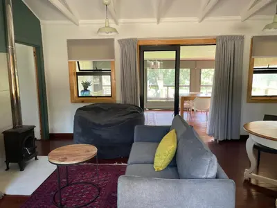 a living room with a couch and a table at Idlewood unit 2 in Dullstroom