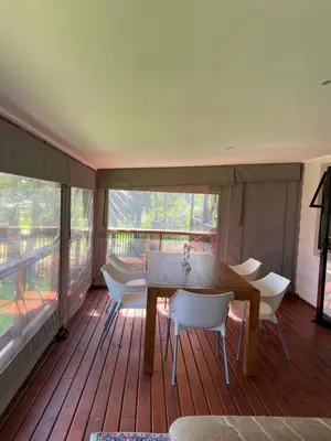 a dining room with a table and chairs on a deck at Idlewood unit 2 in Dullstroom