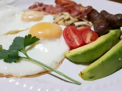 a plate of food with an egg and vegetables at Almar View Guest House in Nelspruit