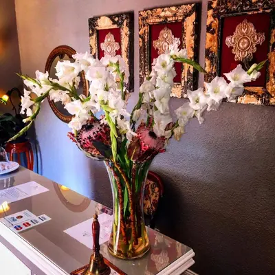 a vase filled with white flowers on a table at Duke & Duchess Boutique Hotel in Pretoria