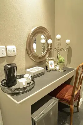 a bathroom with a counter with a mirror and a chair at Duke & Duchess Boutique Hotel in Pretoria