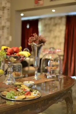a table with plates of food on top at Duke & Duchess Boutique Hotel in Pretoria