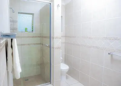 a bathroom with a shower and a toilet at SAR GUESTHOUSE in Benoni