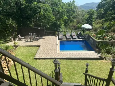 a backyard with a swimming pool and a fence at Safari Bed & Breakfast in Hazyview