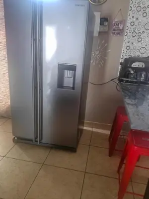 a stainless steel refrigerator in a kitchen next to a counter at ChoosersExpressHotel in Centurion