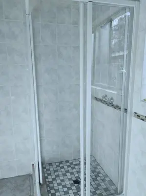 a shower with a glass door in a bathroom at ChoosersExpressHotel in Centurion