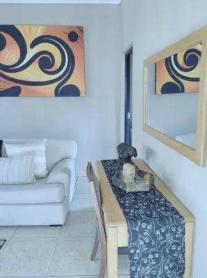 a living room with a table and a couch at ChoosersExpressHotel in Centurion