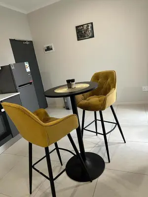 a table and two chairs in a room at Midrand E Airbnb in Midrand
