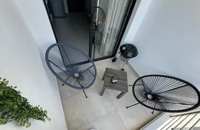 two blue chairs and a table in a room at Midrand E Airbnb in Midrand