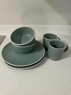 three green bowls and plates sitting on a counter at Midrand E Airbnb in Midrand