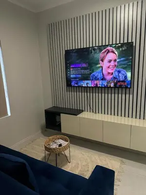 a living room with a flat screen tv on a wall at Midrand E Airbnb in Midrand