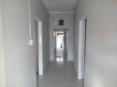 an empty hallway with white walls and a long corridor at Las Palmas Day & Night Guest House in Pretoria