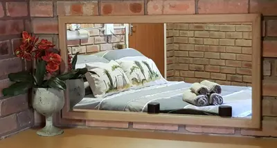 a mirror reflection of a bed in a room at Klein huisie in Marloth Park