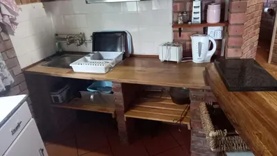 a kitchen with a counter with a sink and a counter at Klein huisie in Marloth Park
