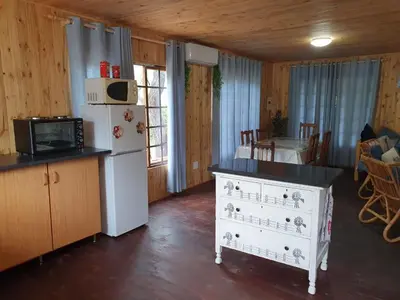 a kitchen with a white refrigerator and a counter top at Hout Huisie in Marloth Park