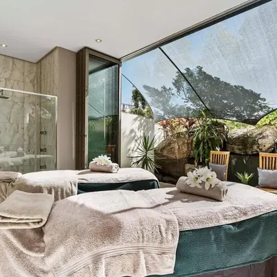 a room with two beds and a large window at Kashi Skyline: Live . Shop . Work . Play in Midrand