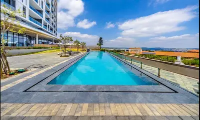 a swimming pool on the roof of a building at Kashi Skyline: Live . Shop . Work . Play in Midrand