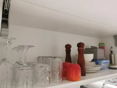 a shelf filled with glass vases and plates at Kashi Skyline: Live . Shop . Work . Play in Midrand