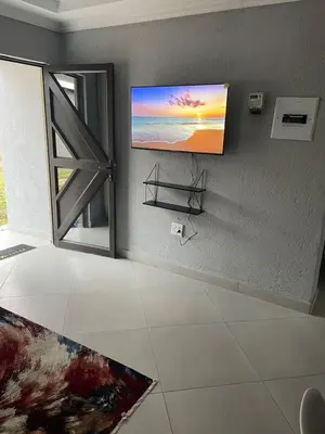 a living room with a painting on the wall at Tranquility at Homely Escape in Phalaborwa