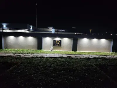 a building with lights on the side of it at night at The Residence Villa in Musina