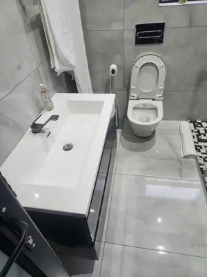a bathroom with a white sink and a toilet at The Residence Villa in Musina