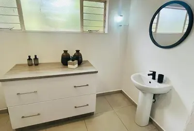 a bathroom with a sink and a mirror at The Hart House in Hartbeespoort