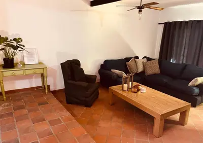 a living room with a couch and a coffee table at The Hart House in Hartbeespoort