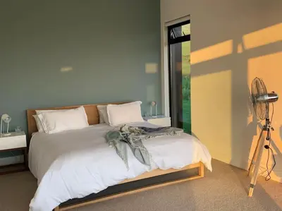 a bedroom with a bed with a camera on a tripod at Walkersons Estate- Outcrop in Dullstroom