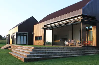 a house with a staircase leading up to it at Walkersons Estate- Outcrop in Dullstroom