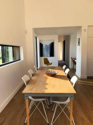 a dining room with a wooden table and chairs at Walkersons Estate- Outcrop in Dullstroom