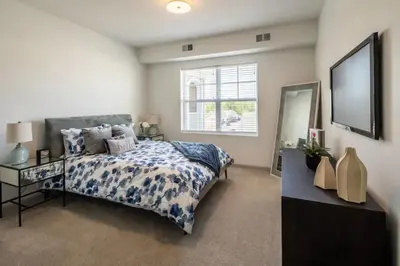 a bedroom with a bed and a large window at The Grove in Pretoria