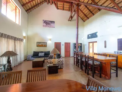 a living room with a couch and a table at Kruger Wildlife Villas in Phalaborwa