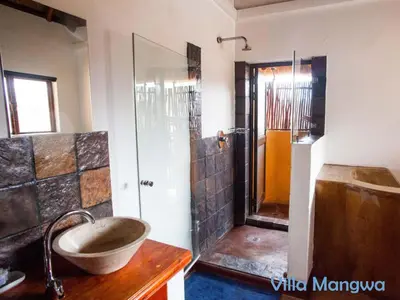 a bathroom with a sink and a shower at Kruger Wildlife Villas in Phalaborwa