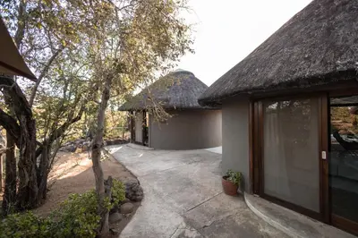 an entrance to a house with a thatched roof at Nsala Wilderness Camp in Timbavati Game Reserve