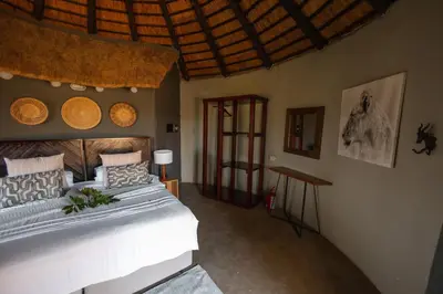 a bedroom with a large bed in a room at Nsala Wilderness Camp in Timbavati Game Reserve