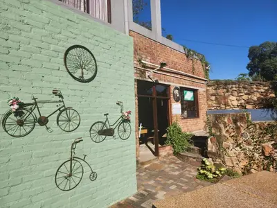 two bikes are on the side of a brick building at An Exclusive Guesthouse too in Nelspruit
