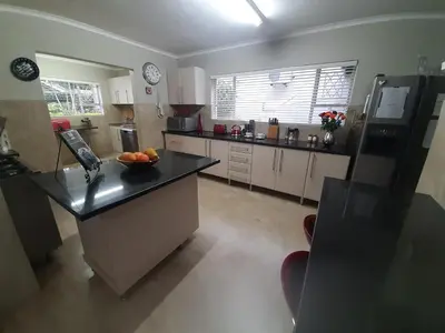 a kitchen with a bowl of fruit on a counter at Leadwood Guesthouse in Tzaneen