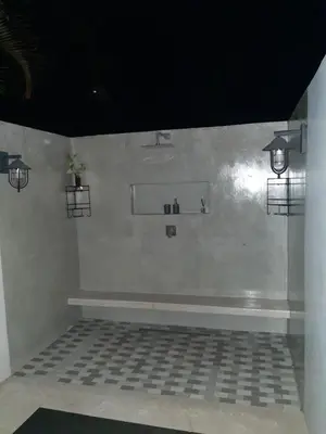 a white room with two lights on the wall at Leadwood Guesthouse in Tzaneen